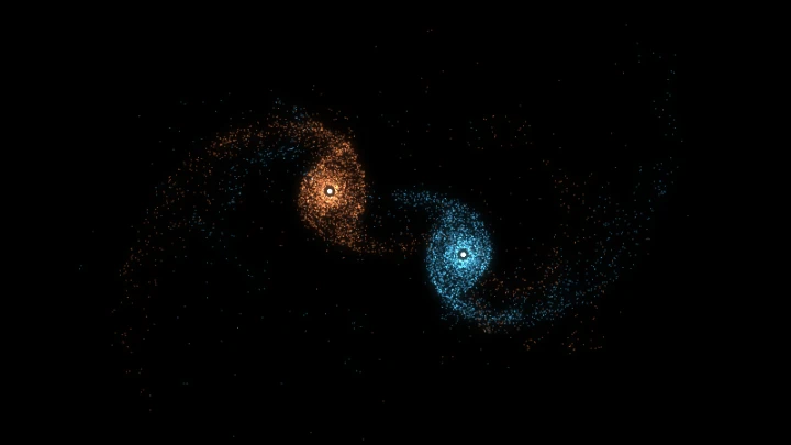 Barnes-Hut simulation of two colliding galaxies, pulling long tidal tails of stars out of each other